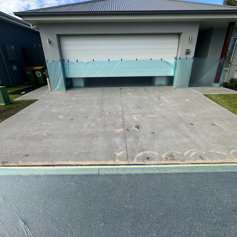 Worn concrete driveway before resurfacing